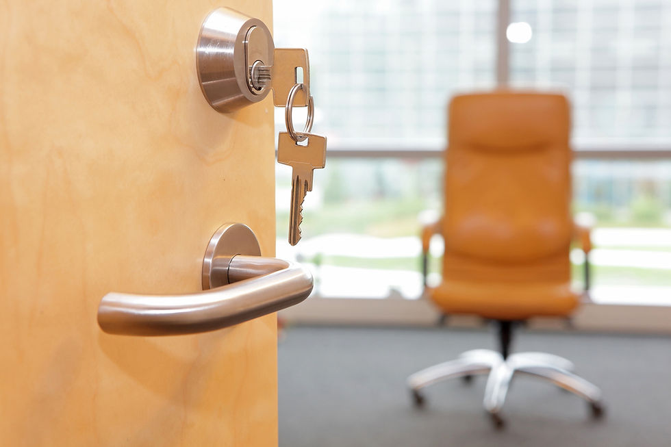 Commercial locksmith installing keys in an office door lock.