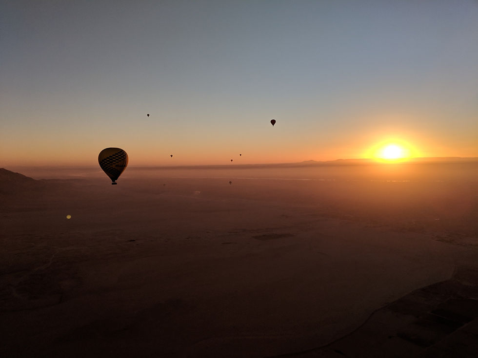 Sunrise balloon ride over the Nile River and adjoining desert.