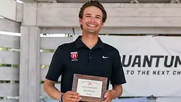 Justin Callahan holding the 2026 College Sailor of the Year Award