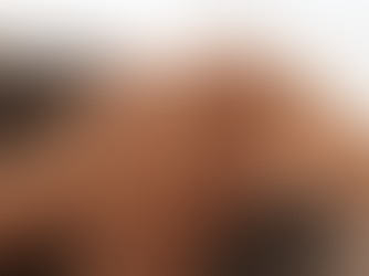 Two hands clasping each other gently over a striped fabric, depicting comfort and support. The setting is soft and neutral in color.