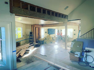 A room under construction featuring a door and window, part of an Oakland home renovation project.