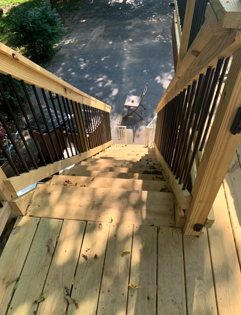 Wood stairs sturdy and safe with black metal railings
