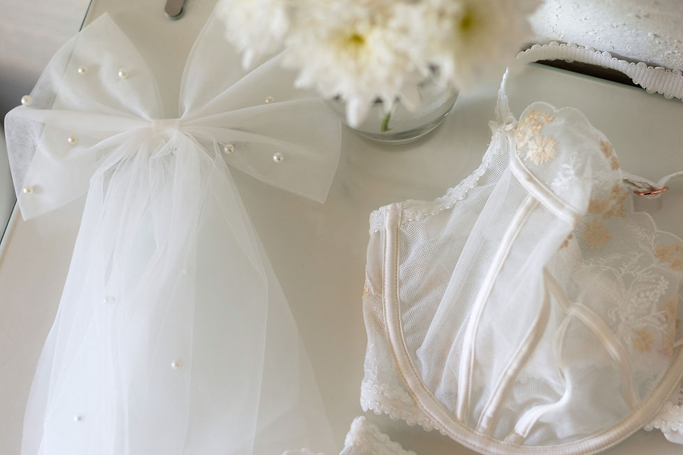 A white bow, flowers, and bra