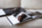Boudoir albums laid out flat on a sofa