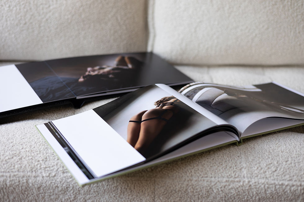 Boudoir albums laid out flat on a sofa