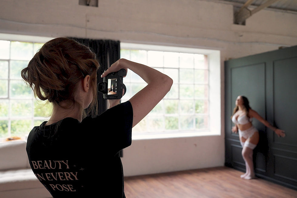 Photographer taking a photo of a woman in white bridal lingerie