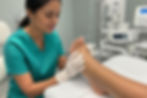 Podiatrist examining a patient foot during checkup.