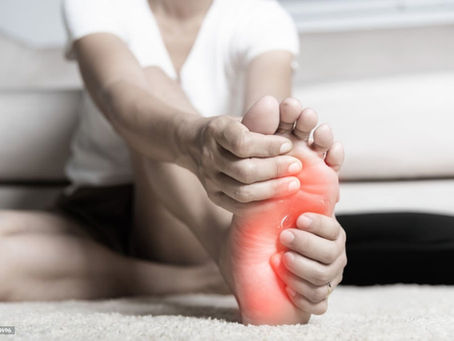 Person massaging tired legs caused by hidden foot problems.