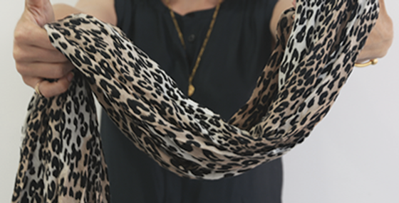 Leopard scarf held by woman