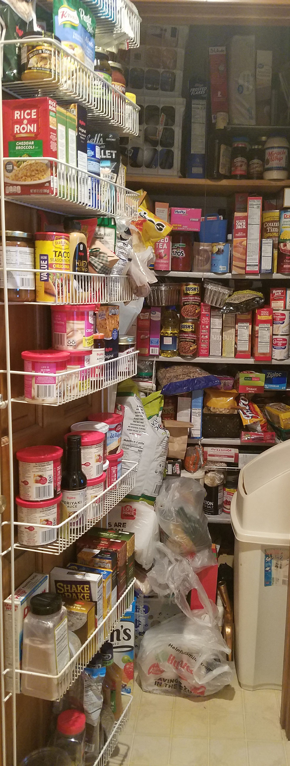 An overstocked, overstuffed pantry closet.