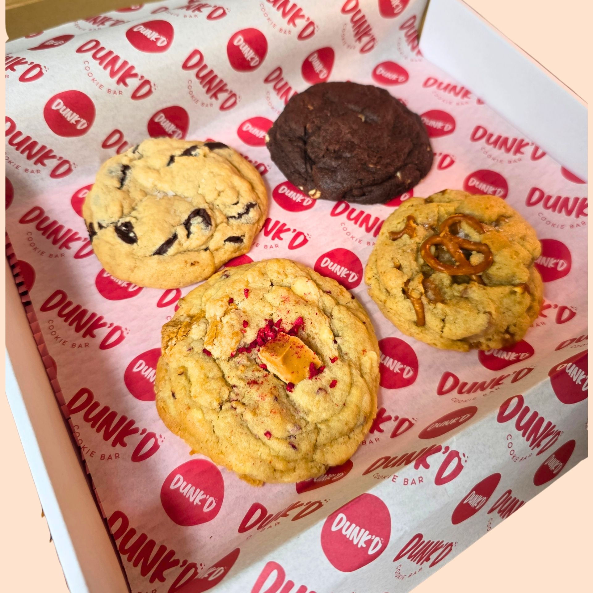 1 chocolate chip sea salt, 1 salted caramel pretzel cookie and 1 ultimate chocolate cookie and 1 raspberry cookie