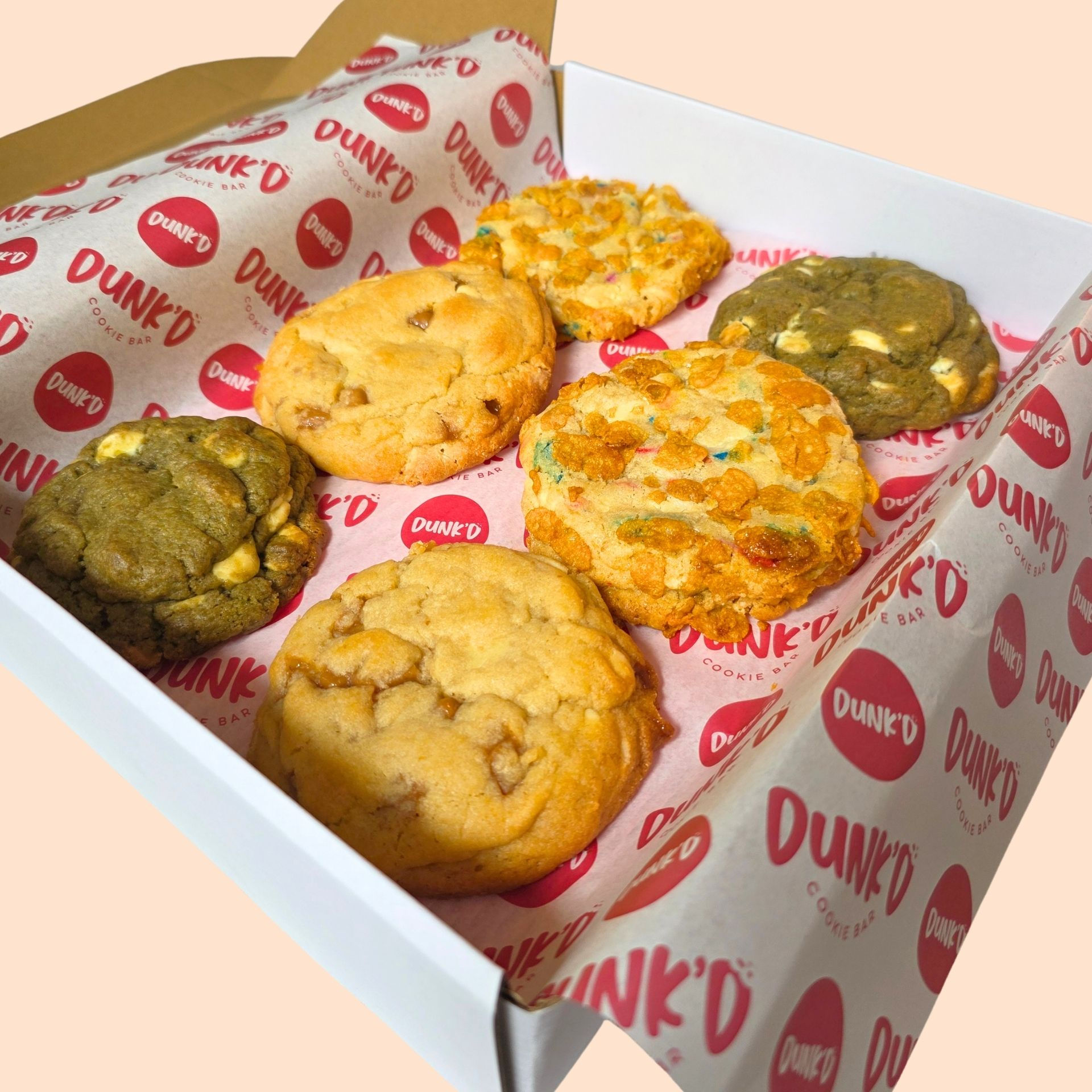 2 cereal milk funfetti cookies and 2 miso, caramel white chocolate cookies, 2 matcha white chocolate in a box