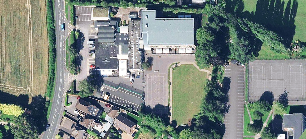Aerial view of Fairmead School campus, showing buildings, playground, and parking