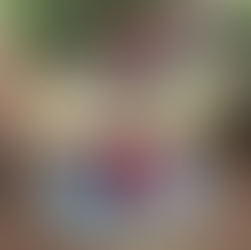 Wooden table with potted flowers on display in a garden setting at FairmeadSchool