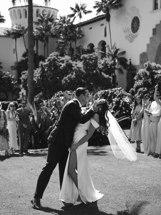 Editorial-Style Couple’s Portrait Against Spanish Architecture. A clean and elegant wedding photo showcasing natural connection, soft lighting, and classic Santa Barbara architectural textures.