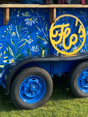 Floral pattern painted on blue horsebox bar