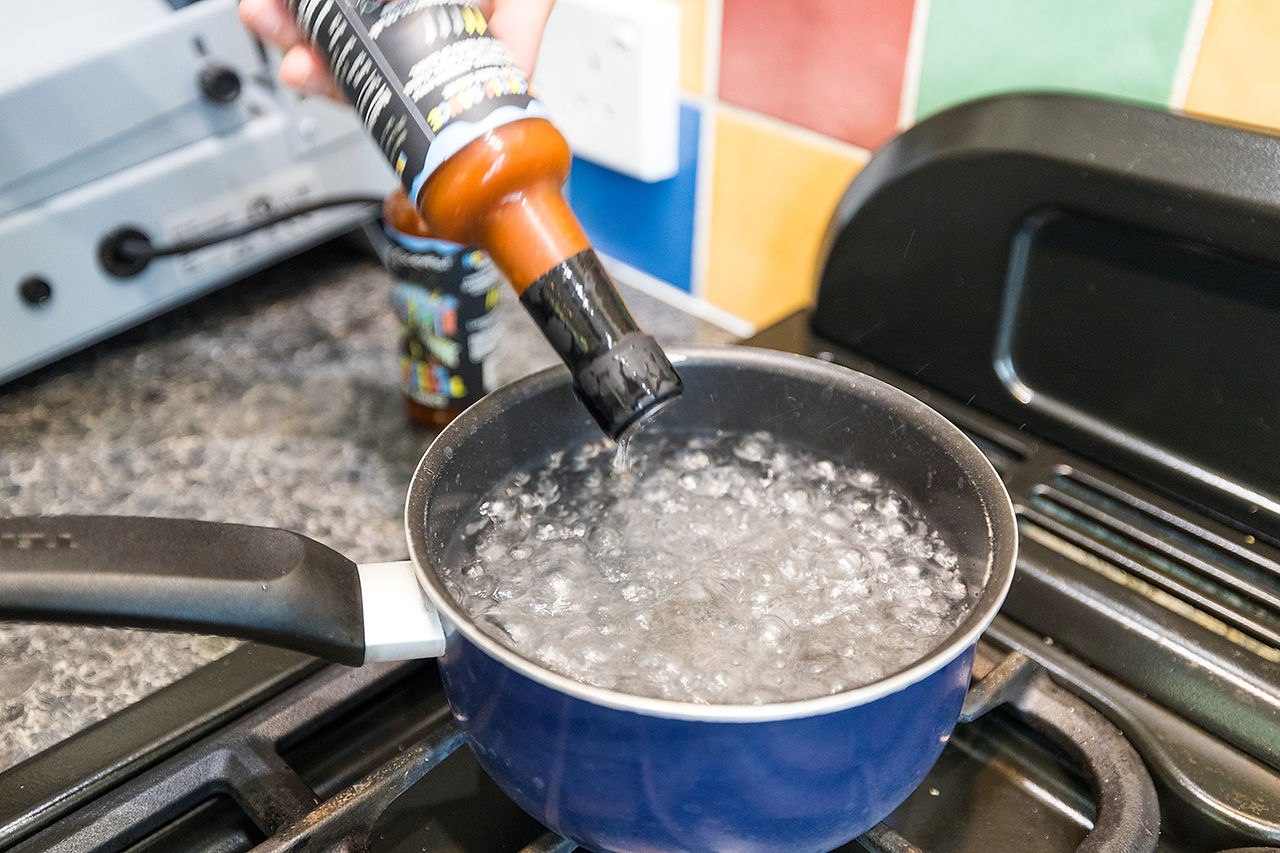 Using a pan of boiling water to shrink a Heat shrink capsule