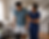 Man on crutches with leg brace assisted by caregiver