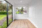 bedroom view with large format sliding windows inside the 40ft 2 bedroom Coastal Luxe container home