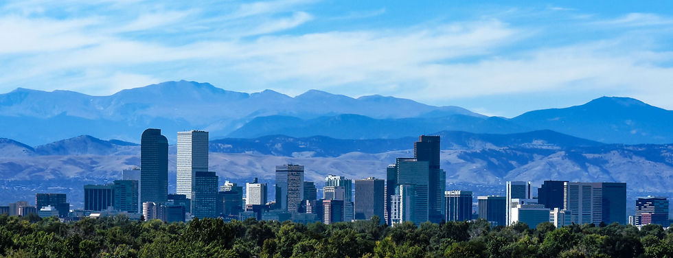 Denver skyline with mountains in the background, a beautiful blue sky.