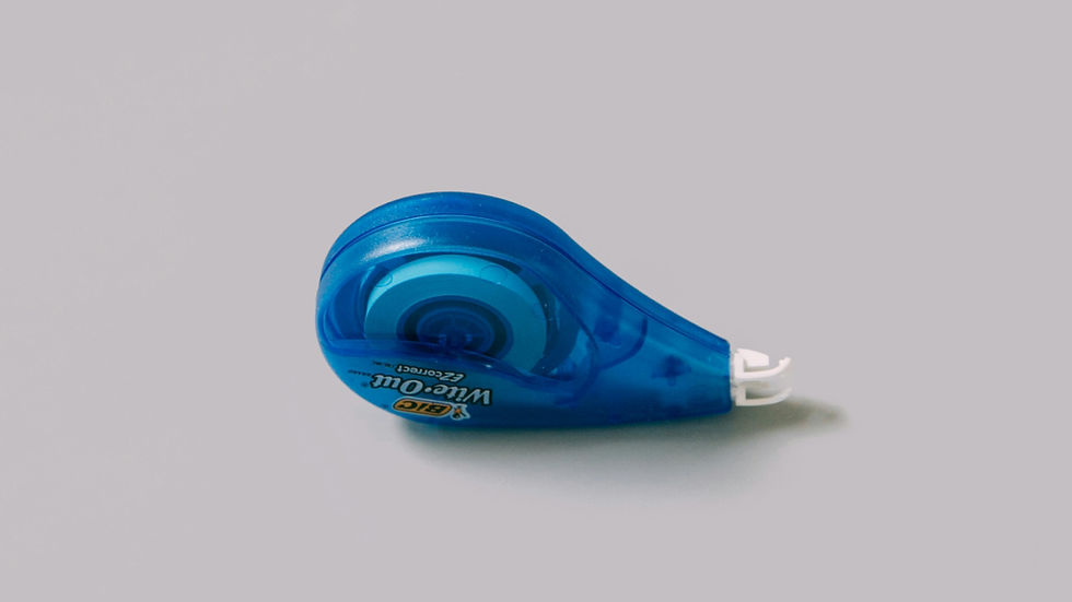 Blue BIC Wite-Out EZ Correct correction tape dispenser on a plain white background, shown in close-up.