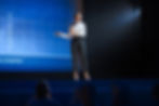 A business professional doing a presentation on stage at a conference
