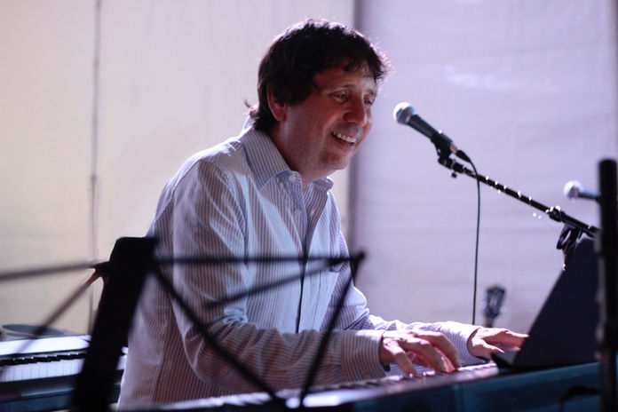 Bob Mamet playing piano, smiling face