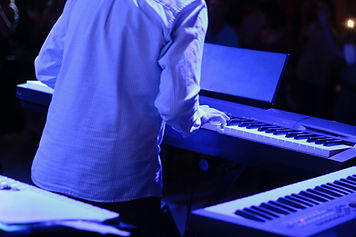 Bob Mamet's hands on the piano, glowing purple lighting