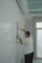 Man plastering the walls of a shop