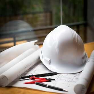 Planning documents and hard hat representing the Government’s housing targets and the role of lenders like Funding 365