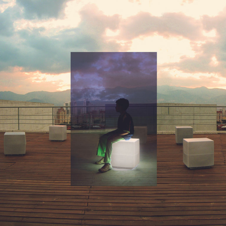 Boy sitting on a cubic chair