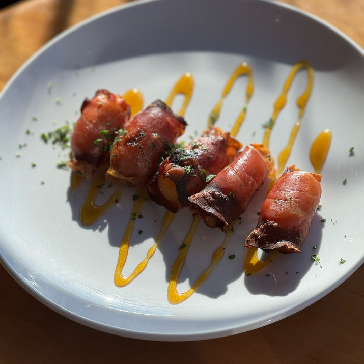 Image of bacon wrapped dates at Bascule Bridge Grille