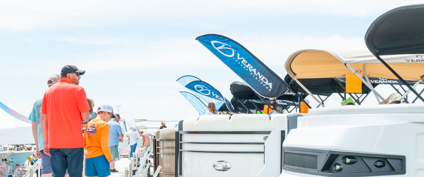 People viewing boats docked at a show