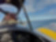 the back of the pilots head looking out of the cockpit as you fly over the coast