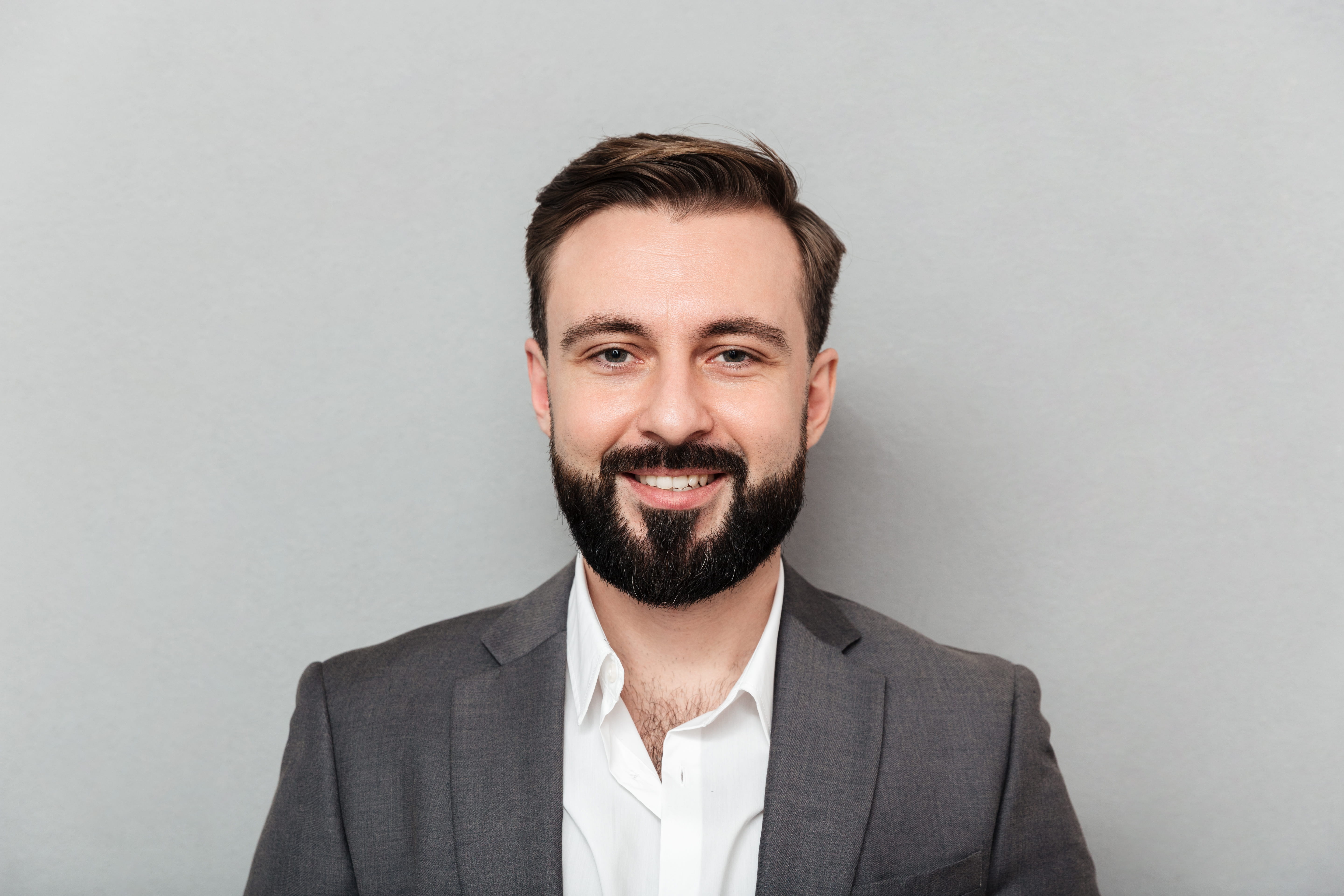 close-up-portrait-young-bearded-man-white-shirt-jacket-posing-camera-with-broad-smile-isol
