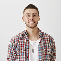 awkward-smiling-young-guy-with-glasses-posing.jpg