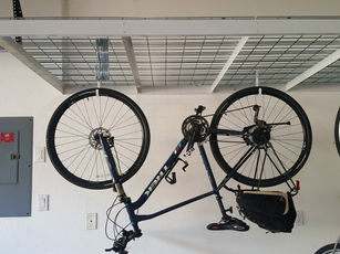 Rack with hanging bicycle