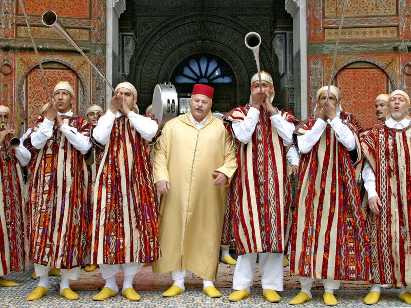 Aissawa musicians in traditional Moroccan dress performing in Fez