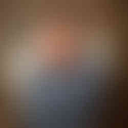 Newborn baby Eliab wrapped in blue fabric and posed in a basket with natural textures in Aurora newborn photography studio