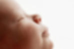 Side profile close-up of a sleeping newborn showing soft cheeks, nose, and lips, captured during a timeless newborn photography session in Aurora, Colorado.