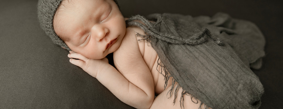 Newborn baby Luca in woodland-inspired newborn photography setups featuring a fox bonnet, rustic wraps, warm fall colors, and close-up newborn details in an Aurora Colorado studio.