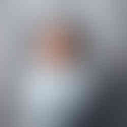 Newborn baby Eliab posed in a wicker crib prop wearing a knit hat during Aurora newborn photography session