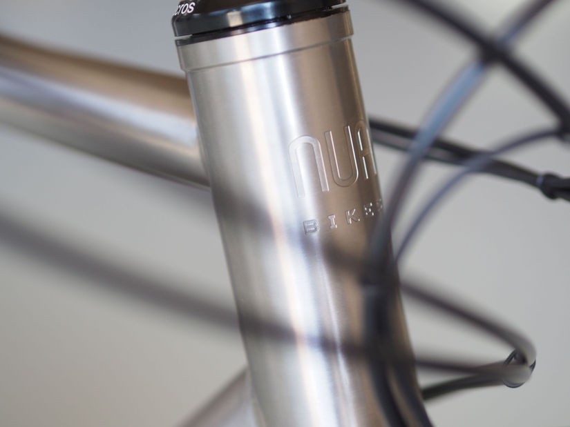 Close up of the Titanium frame with engraved logo on the Luna Rohloff touring and commuter bike