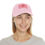 Thumbnail: Woman smiling, wearing pink baseball cap with logo