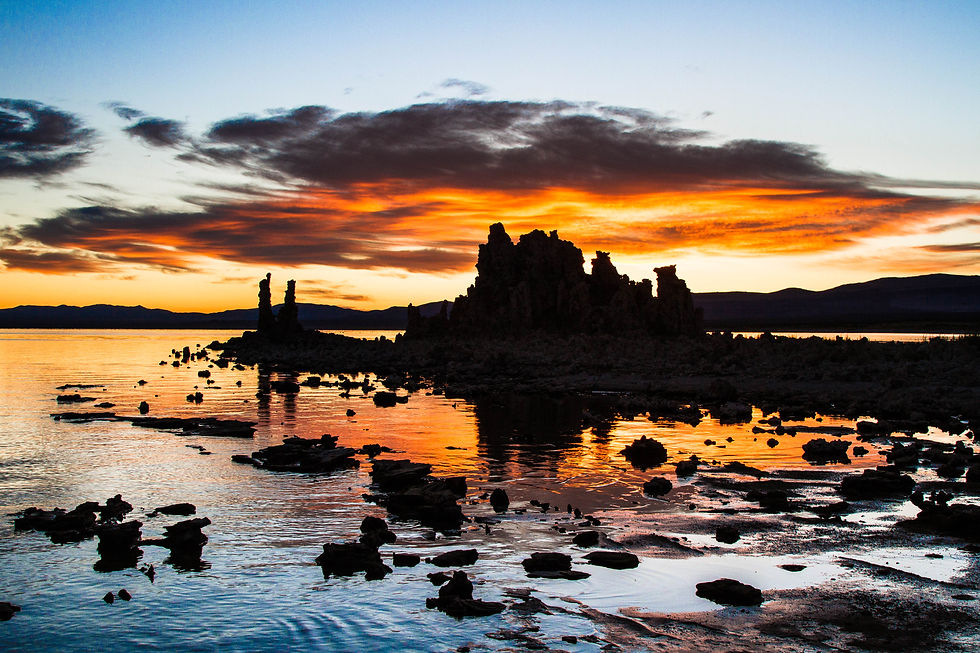 Tufa Towers at sunrise at Navy Beach with the orange clouds reflected in the water