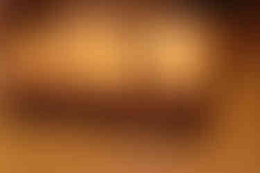 The upside down game bottom part of the BOOoop game being used as the bed frame with the game board quilt on top and a game in progress.