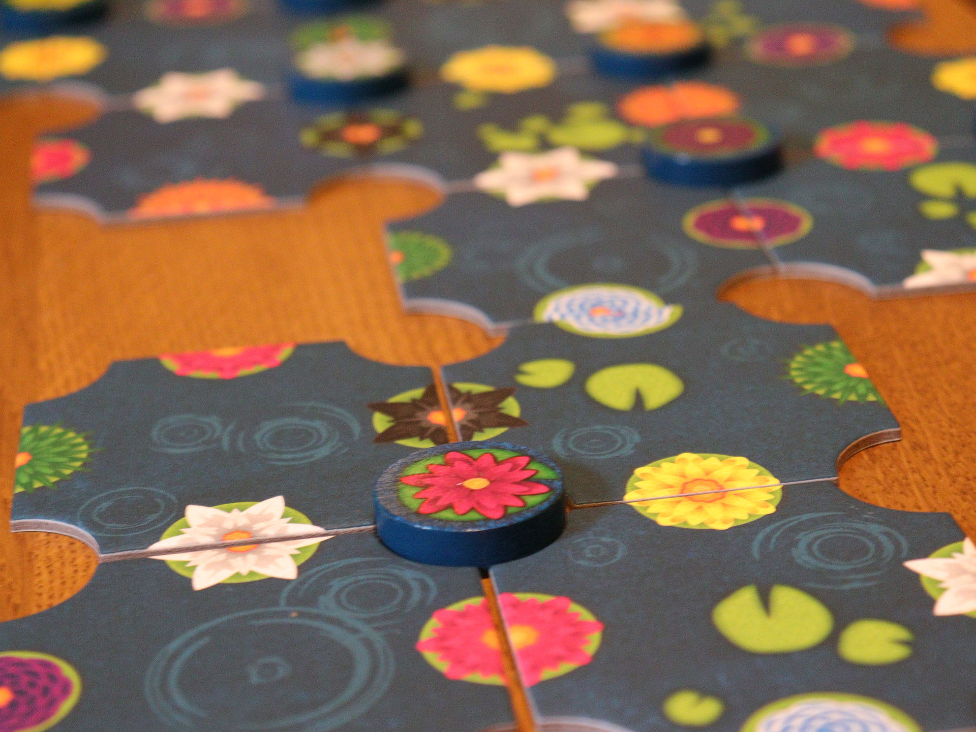 A close up shot of a game in progress of a gentle rain showing the completed pink flower token