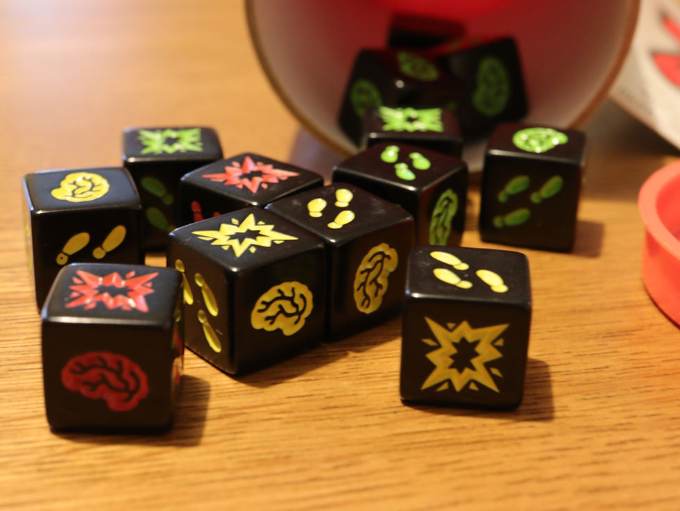 A close-up of the dice from Zombie Dice spilling out of the game box.