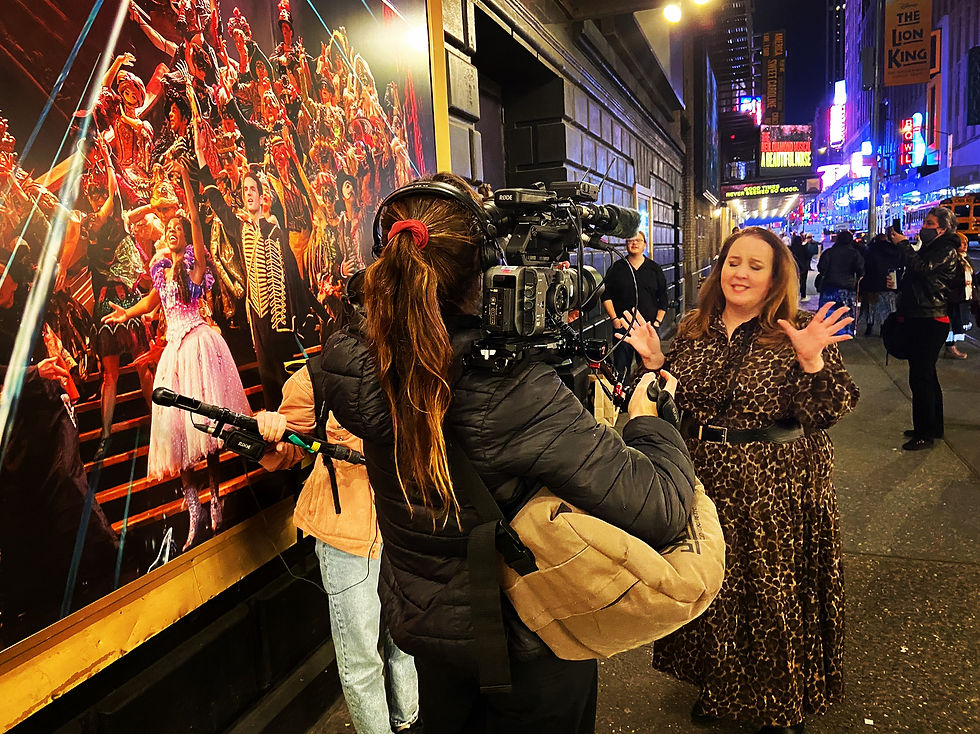 Kim Davis films for The BBC Travel Show outside the Majestic Theatre in New York City,, where The Phantom Of The Opera has played for 35 years.