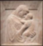 Image of The Pazzi Madonna by Donatello, Dimensions about 4 feet, 7 inches (1.40 meters) tall Location Berlin State Museums, Germany Dated c. 1420. Slightly raised sculpture of madonna and baby in tan and specks of brown.